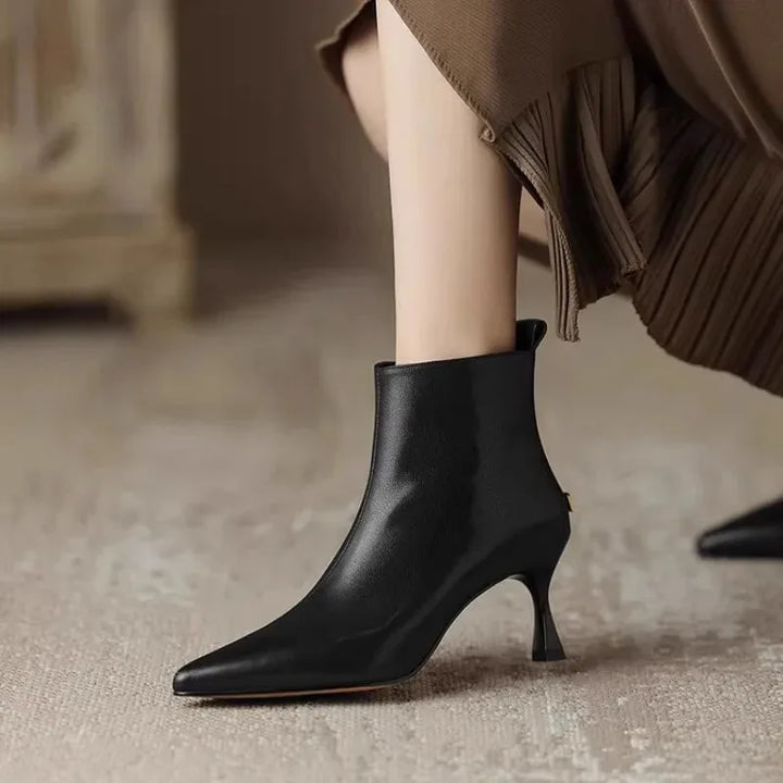 Women's faux leather side zip ankle winter boots with 'uim' lettering