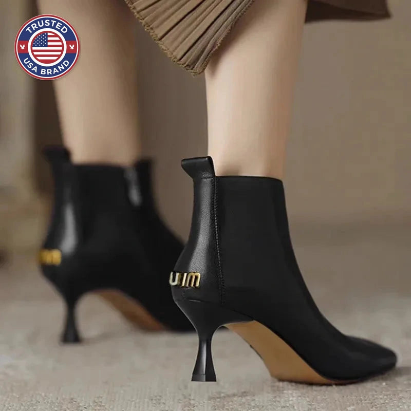 Women's faux leather side zip ankle winter boots with 'uim' lettering
