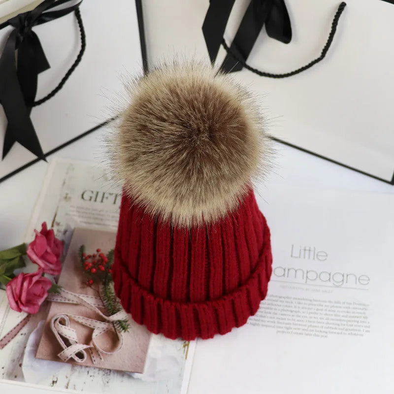 Women's ribbed winter top with detachable faux fur pom-pom