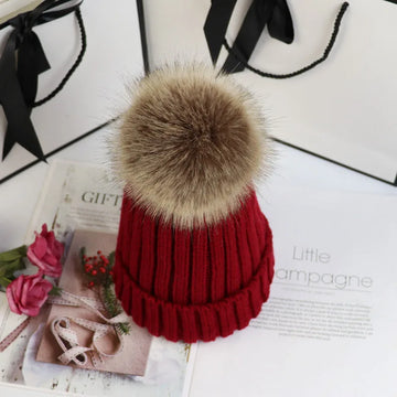 Women's ribbed winter top with detachable faux fur pom-pom